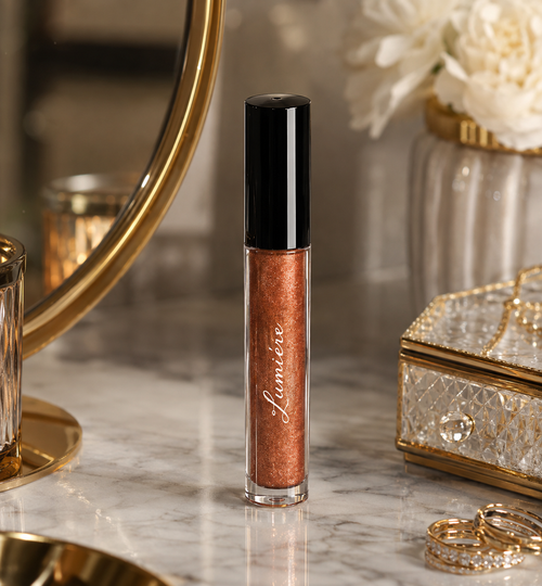 Lumière Gilded Copper lip gloss on a marble vanity