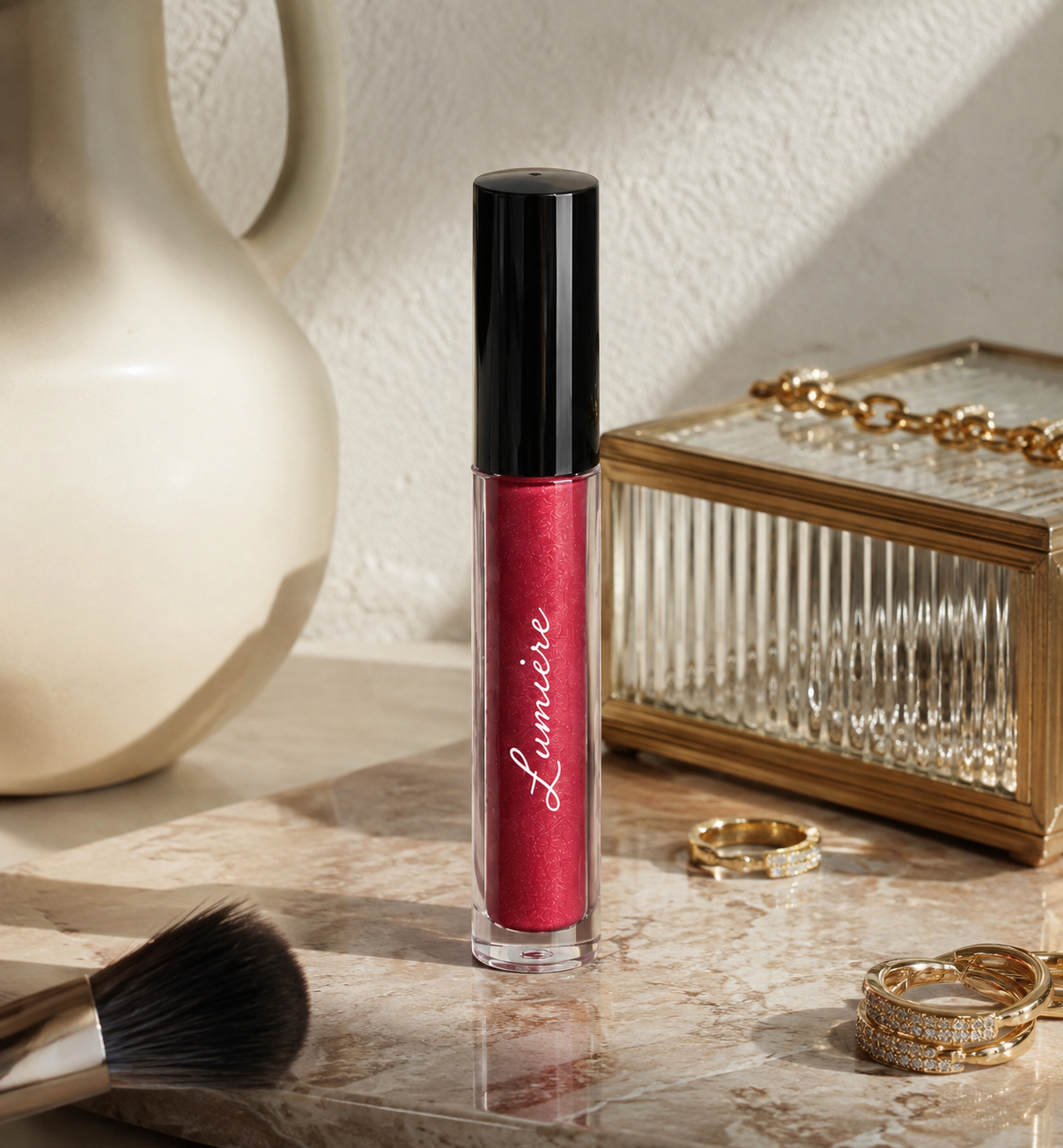 Lumière Ruby Glitz lip gloss on a marble vanity