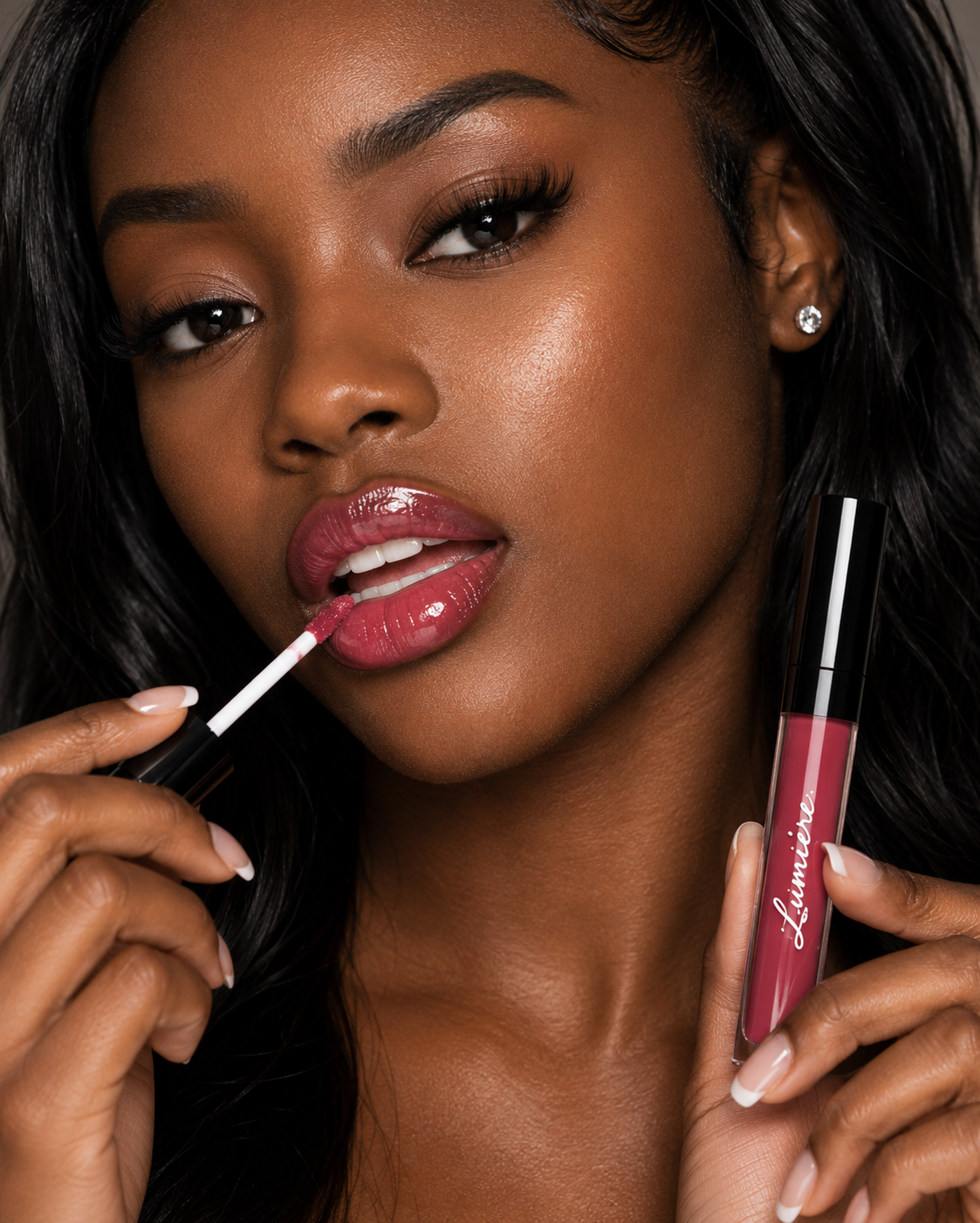 Model applying Lumière Velvet Rose lip gloss